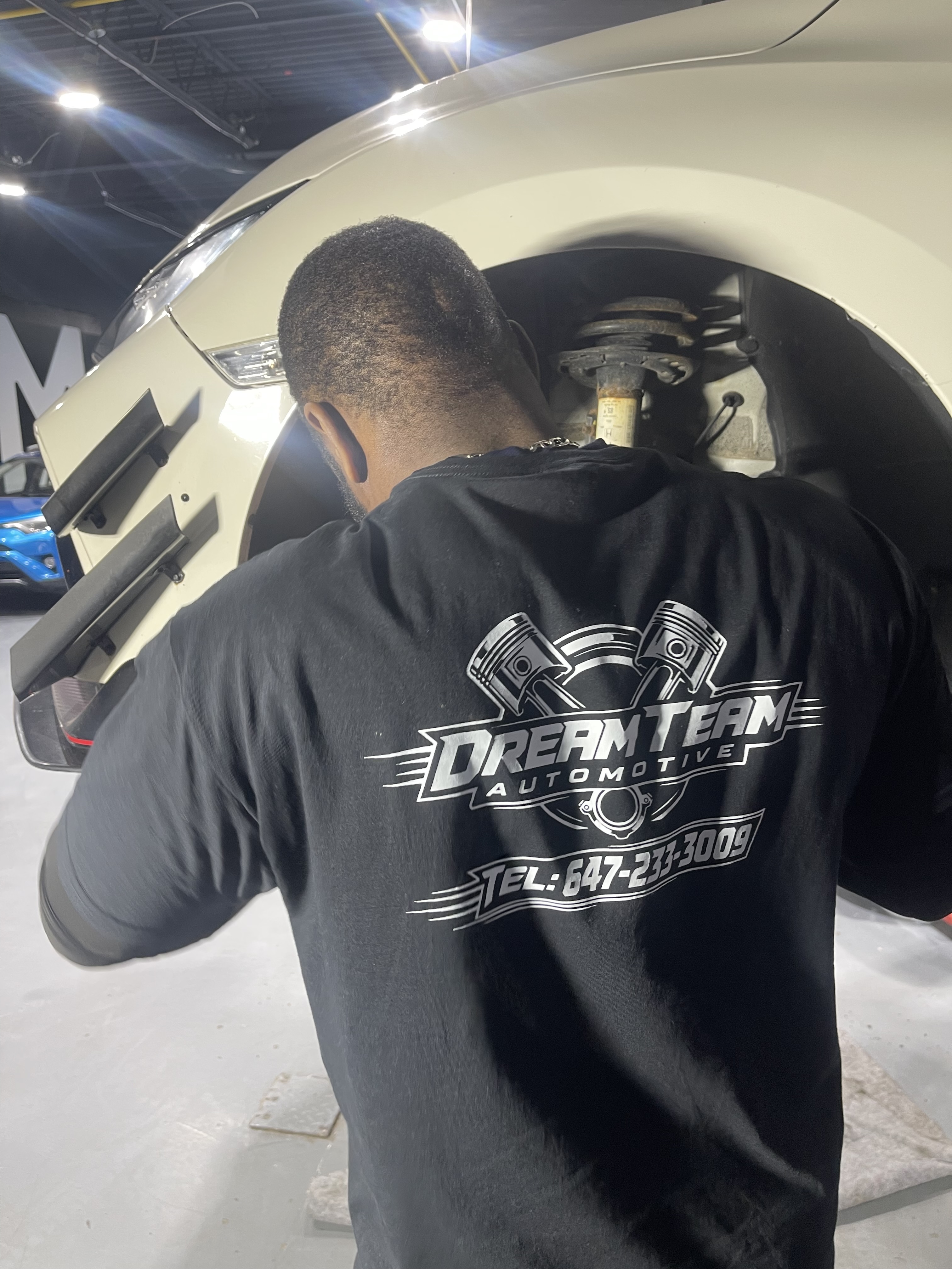 Dreamteam Automotive mechanic working on a wheel, Mississauga